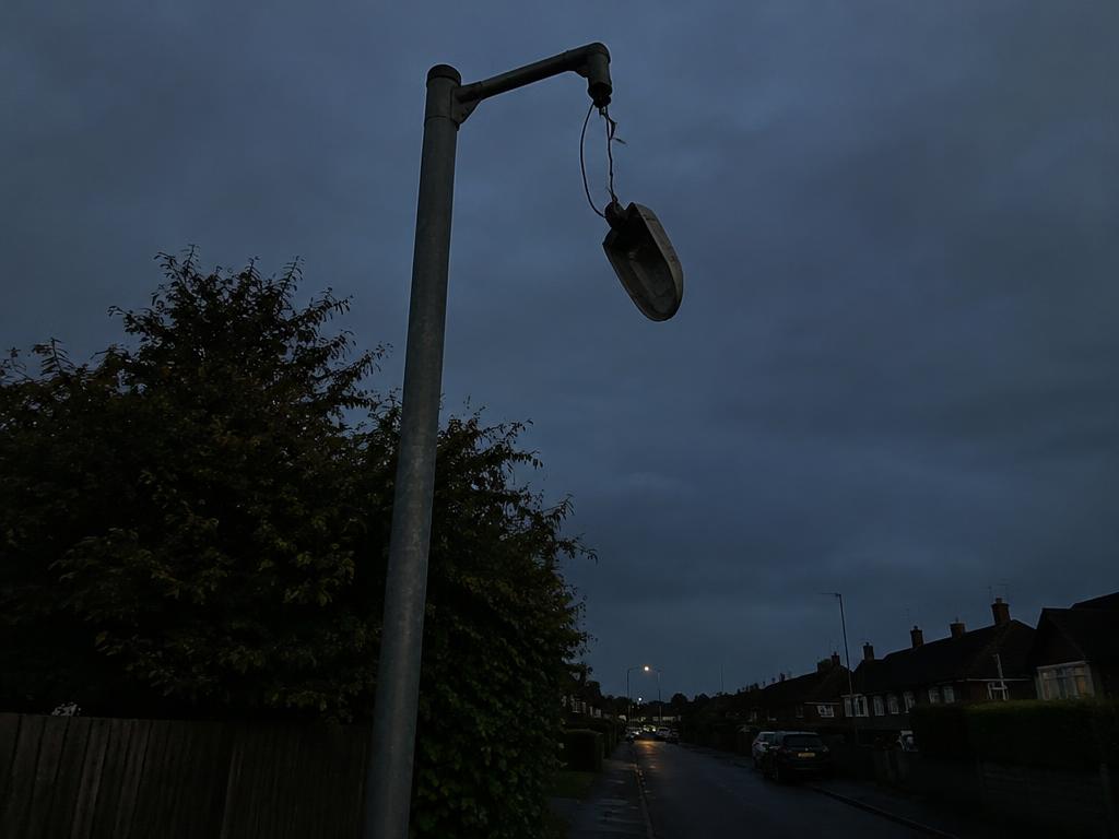 Streetlight hanging dangerously from pole